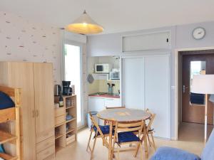 a kitchen and dining room with a table and chairs at Studio~ Les pieds dans l'eau 2~ in Donville-les-Bains