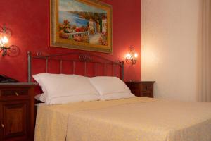 Postel nebo postele na pokoji v ubytování Hotel Gangi