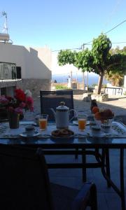 a table with a teapot on top of it at Villa Olga in Agalianós