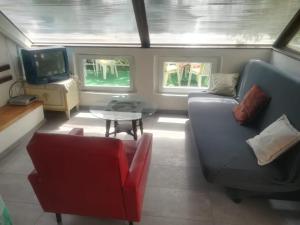 a living room with a couch and a table at Apartments Darinka in Opatija