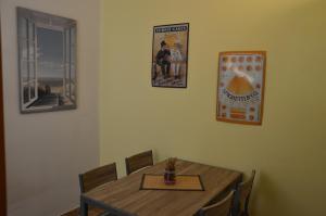 ein Esszimmer mit einem Tisch und einem Bild an der Wand in der Unterkunft Ferienhaus Am Park in Löbnitz