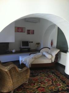 a bedroom with a bed and a chair in a room at Cà d'Estrina in Bonassola