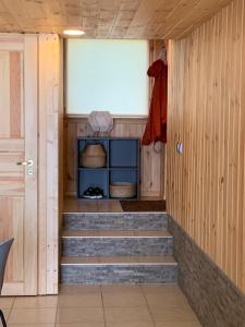 a hallway with stairs in a room with a door at Small Vinter Summer House in Käsmu