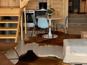 a kitchen with a table and chairs in a room at Small Vinter Summer House in Käsmu