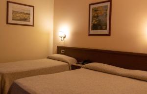 Postel nebo postele na pokoji v ubytování Hotel Gangi