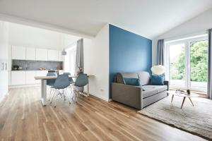 a living room with a couch and a table at Boardinghome Oldenburg in Oldenburg