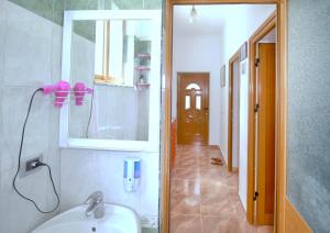 a bathroom with a sink and a mirror and a shower at My Home Guest House-Apartment in Durrës