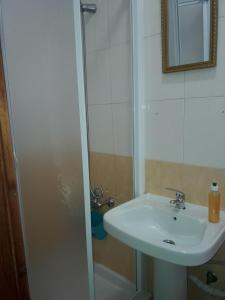 a bathroom with a sink and a shower at Marina's Rooms in Larnaca