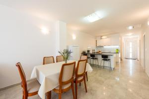 a dining room and kitchen with a table and chairs at Sea Sky Apartment in Cavtat