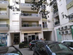 a parking lot with cars parked in front of a building at Apartman Borislava in Trebinje
