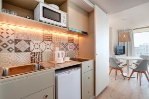 a kitchen with a sink and a microwave at Protur Atalaya in Cala Millor
