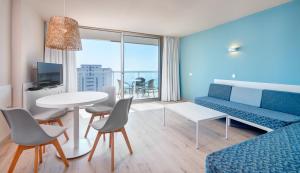 a living room with a couch and a table at Protur Atalaya in Cala Millor