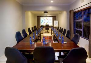 a conference room with a long table and chairs at Heugh Road Guest House in Port Elizabeth