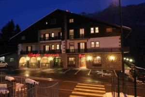a hotel in the mountains at night at Hotel Des Alpes in Castione della Presolana