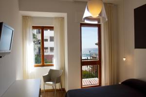 TV a/nebo společenská místnost v ubytování Hotel La Playa