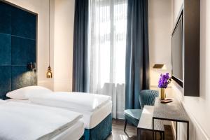 Säng eller sängar i ett rum på Hotel AMO by AMANO Friedrichstraße