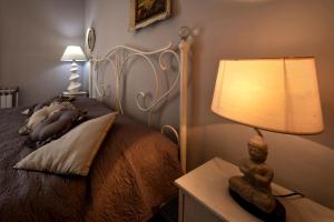 a bedroom with a bed with a lamp on a night stand at Apartment Erceg in Poreč