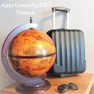 un globo en una mesa con una maleta y gafas de sol en Apartament B&F Poznań Business & Family Nałkowskiej, en Poznan