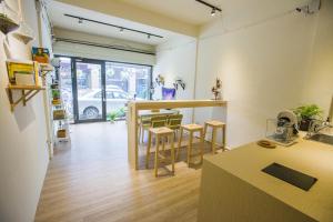 a kitchen with a counter and stools in a room at KM Hostel in Chiayi City