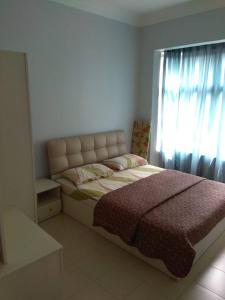 a bedroom with a large bed with a window at PD Homestay Laguna / Ocean Apartment in Port Dickson