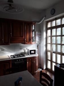a kitchen with wooden cabinets and a stove top oven at OLGATAN in Deiva Marina