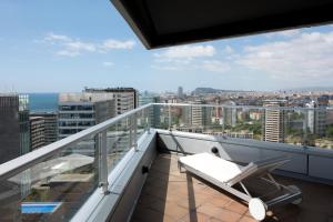 a balcony with a chair and a view of the city at Barcelona Princess in Barcelona