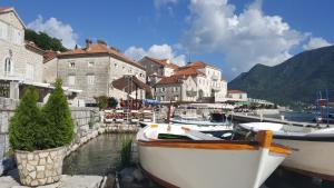 a group of boats docked in a harbor with buildings at Bluemarine Rooms & Apartments in Perast