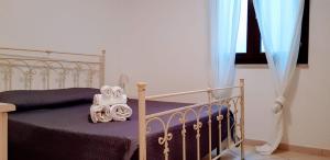 a bedroom with a bed with a white bed frame at Boa Vista Favignana - Nuova Gestione 2026 in Favignana