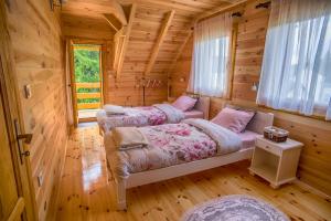 1 Schlafzimmer mit 2 Betten in einem Blockhaus in der Unterkunft Guest house Mickovic in Žabljak