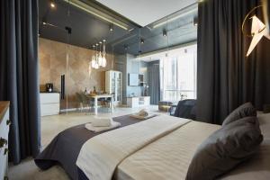 a bedroom with a large bed and a living room at Gagarin Plaza Luxury Sea View Apartments in Odesa +136 photos