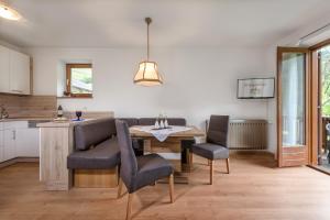 a kitchen and dining room with a table and chairs at Ringlerhof in Braies +8 photos