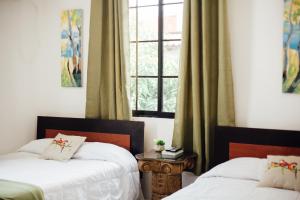 Voodi või voodid majutusasutuse Valley Garden Hotel toas