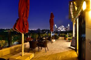 a patio area with tables, chairs and umbrellas at Agora Life Hotel in Istanbul
