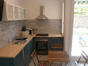 a kitchen with a sink and a stove top oven at Cà Lea,2 Minuti dalla Spiaggia di Monterosso in Monterosso al Mare