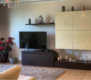 a living room with a large flat screen tv at Apartament Vila Maria in Mamaia