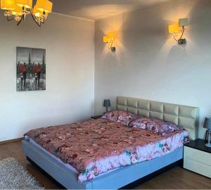 a bedroom with a bed with a red comforter at Apartament Vila Maria in Mamaia