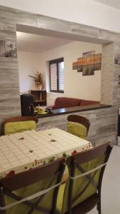 a dining room with a table and chairs at Casa Soarelui in Roşu