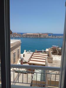 a view of the water from a balcony at ERRIKA in Ermoupoli