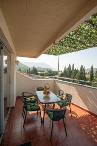 a patio with a table and chairs on a balcony at Dobrljanin LUX apartment in Budva