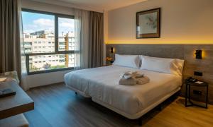 Ein Bett oder Betten in einem Zimmer der Unterkunft Attica 21 Barcelona Mar
