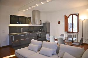 a living room with a white couch and a table at S.M. VICOLO DELL'ORO in San Gimignano