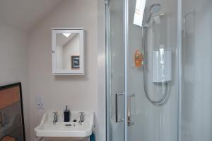 a bathroom with a shower and a sink at Denson Villa in Nairn