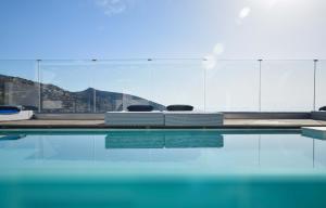 a swimming pool with a view of a mountain at Meliti Hotel (Adults Only) in Agios Nikolaos