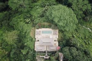 an aerial view of a house in the forest at Villa Santai in Ubud
