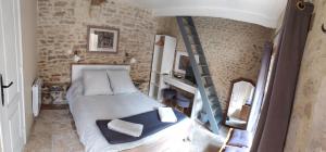 a bedroom with a bunk bed and a ladder at Chambre d´hote En Famille in Bayeux
