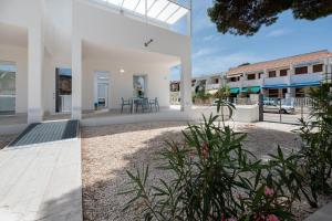 two views of the courtyard of a house at Vitop Residence in San Vito lo Capo