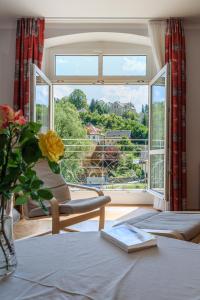 a living room with a large window and a table at Ferienwohnungen Ender in Sebnitz