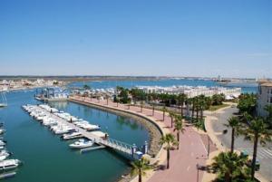 a marina with boats parked in the water at Beach Apartment in Huelva
