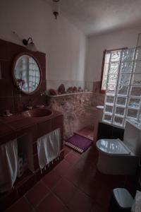 a bathroom with a sink and a toilet and a mirror at La Toscana in Linares de la Sierra