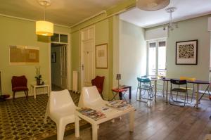 a living room with chairs and a table and a table at Blanca by gaiarooms in León
